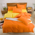 Brushed plain bedding set in brick red colour with duvet cover, sheet and pillowcase on a bed