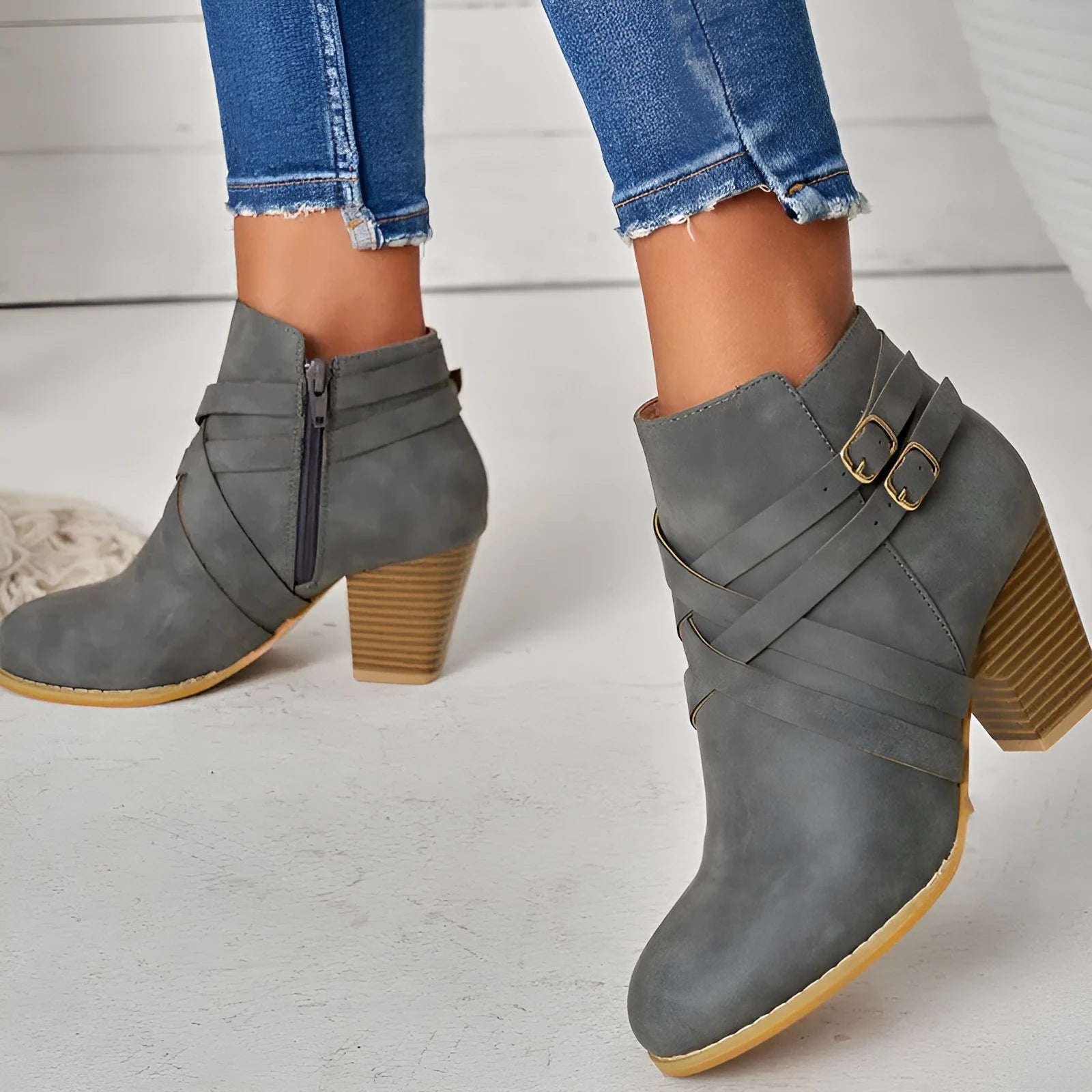Grey plus size ankle boot with a 7cm chunky heel, side zipper, and buckle detail on a plain toe.