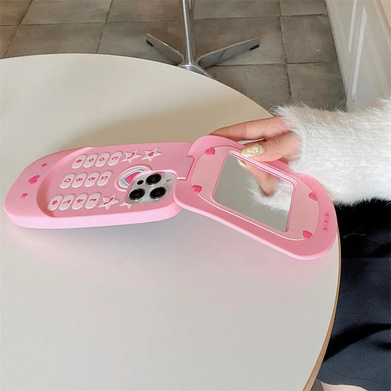 Light pink silicone flip phone case for iPhone with a built-in cosmetic mirror on the front.