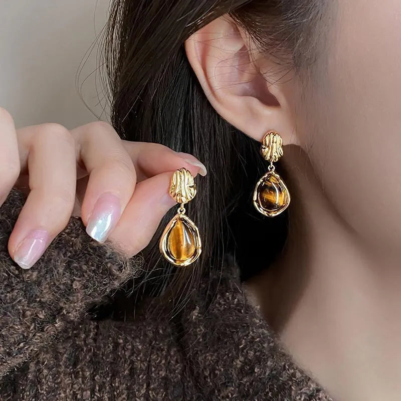 Set of three geometric holiday earrings with tassel elements in different styles