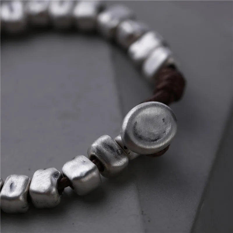 Handmade women's bracelet with irregular silver square and wood on a black elastic band.