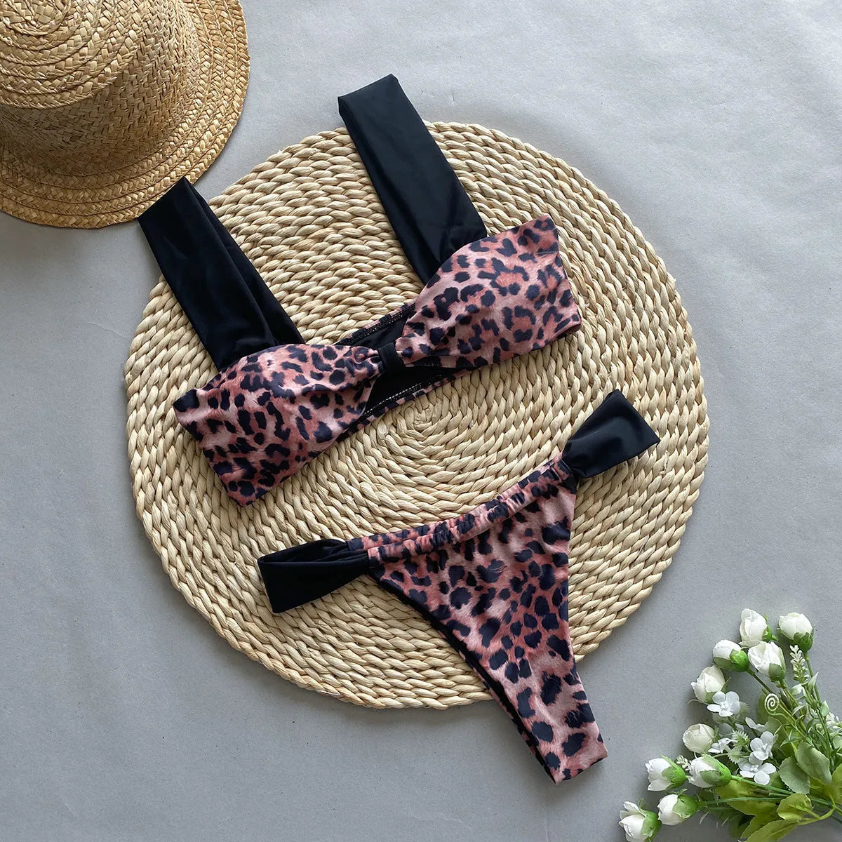 Leopard print women's bikini set showing sleeveless tube top and T-pants on a mannequin.