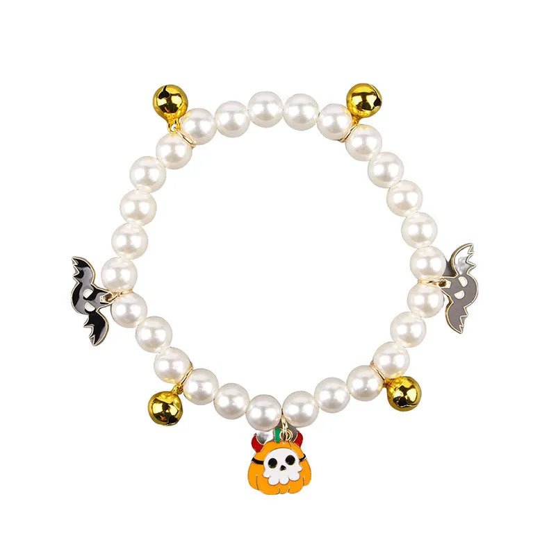 Halloween cat collar with simulated pearls and a choice of purple ghost, skull, or smiling pumpkin print.