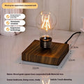 Black iron art suspension bulb decorative night lamp on a wooden desktop.