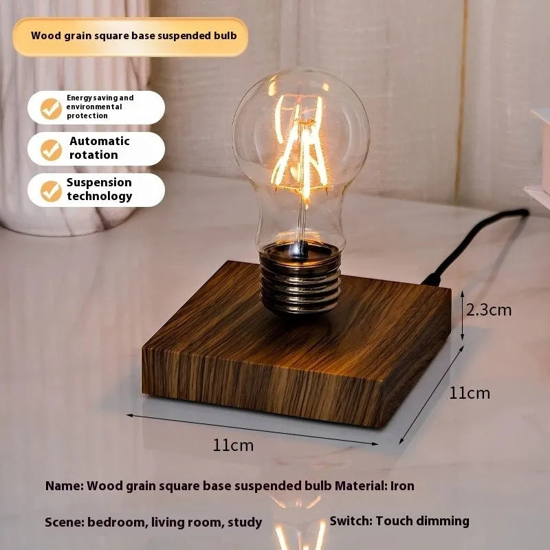 Black iron art suspension bulb decorative night lamp on a wooden desktop.