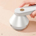 Pilling ball remover device in green or white, USB or battery powered, for sweaters and knitwear