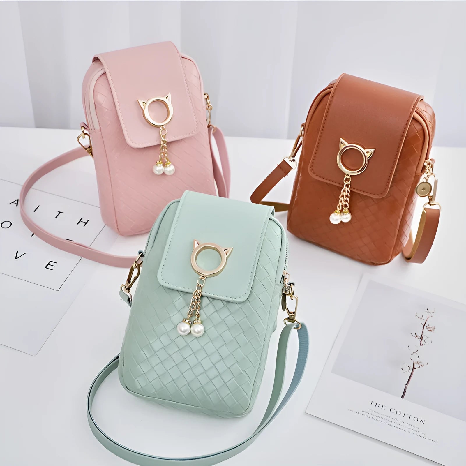 Women's crossbody phone bag with woven pattern, pearl tassel, zipper closure, and bill holder in medium square shape.