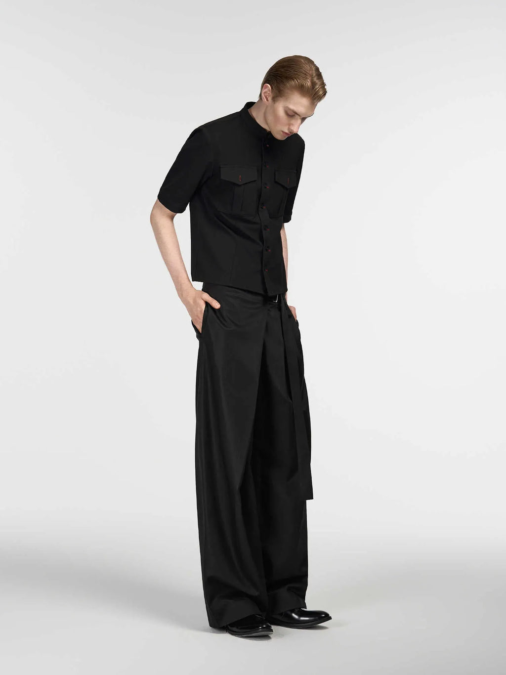 Black women's straight-leg trousers with a single pleat and adjustable waistband on a hanger.