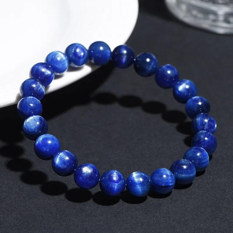 Polished blue geometric crystal bracelet with Ruyi design elements on a wrist.