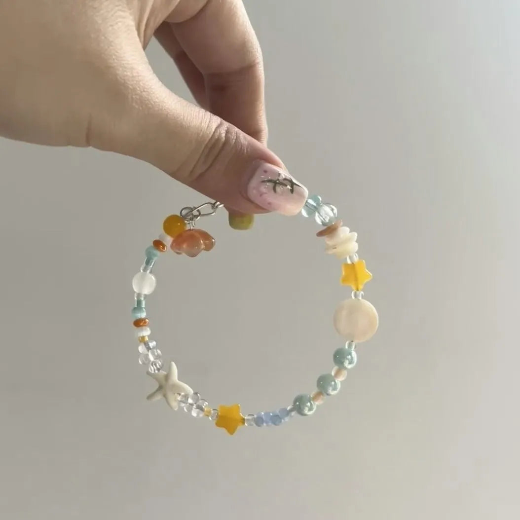 Orange alloy charm bracelet for women with a diamond-shaped charm and round bead details on a silver-tone chain.