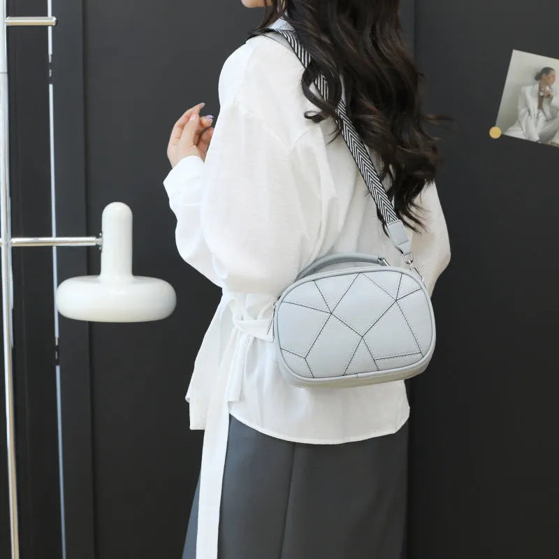 Small round patchwork bag in PU with visible stitching details, shown in beige colour