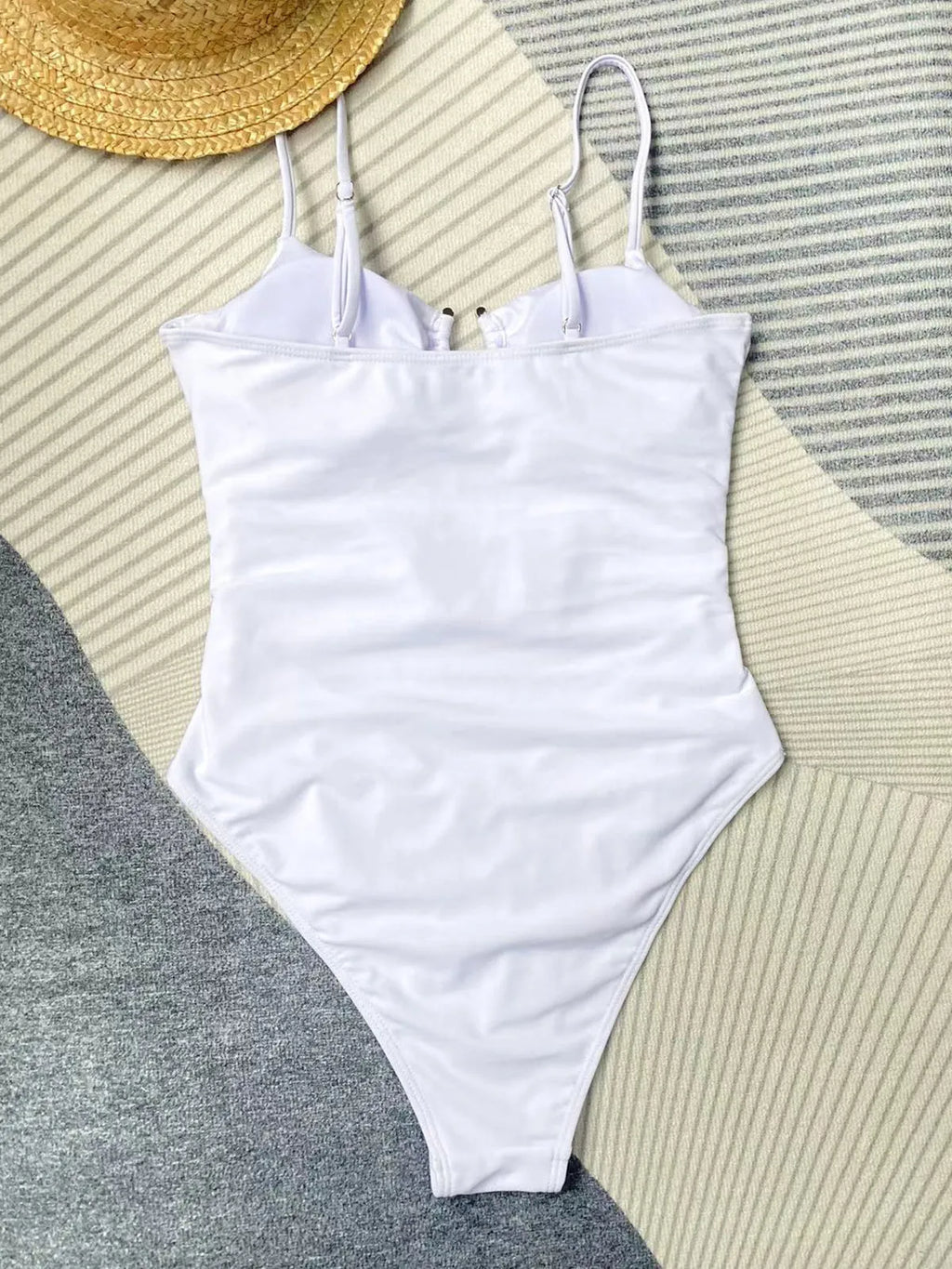 Black solid colour women's one-piece swimsuit on a hanger.