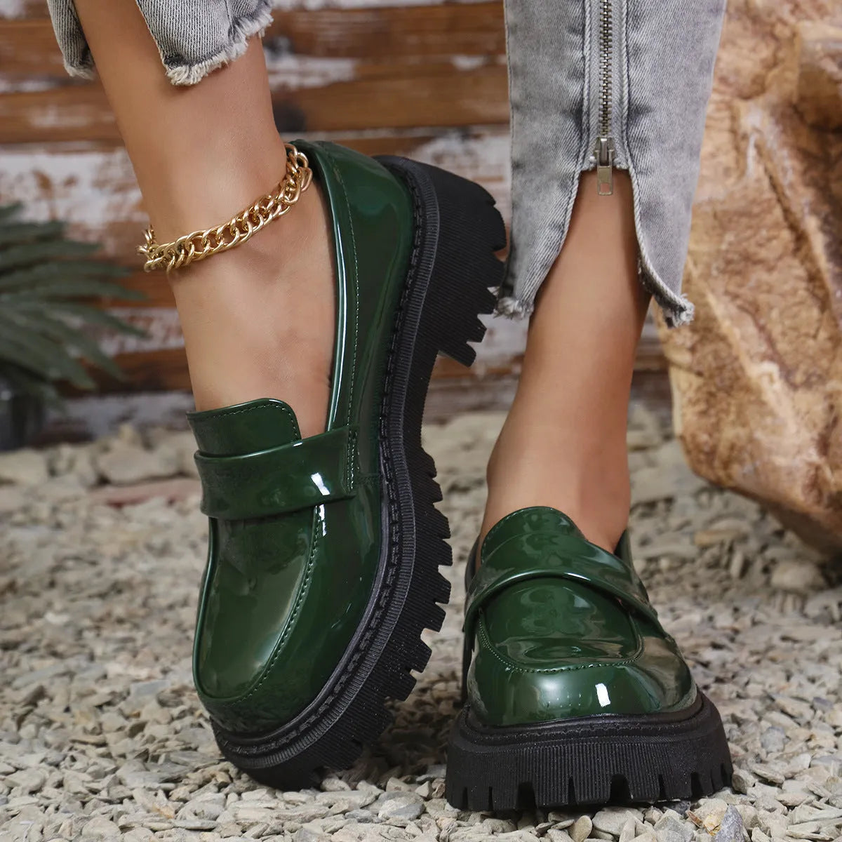 Women's black slip-on loafers with a chunky platform heel and mid-top ankle cut.