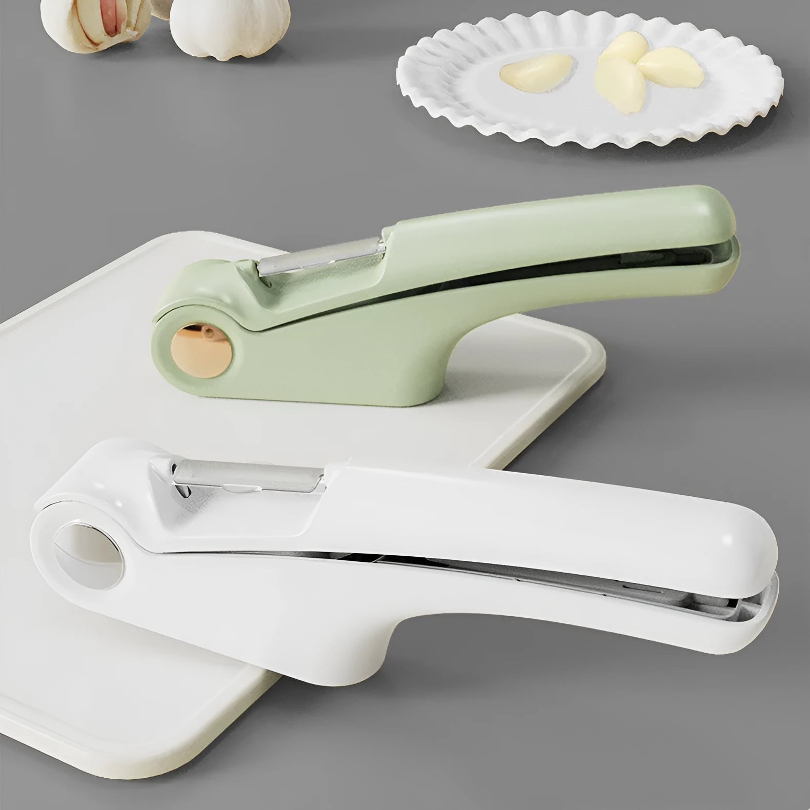 White manual garlic press with stainless steel crusher and ABS plastic handle.