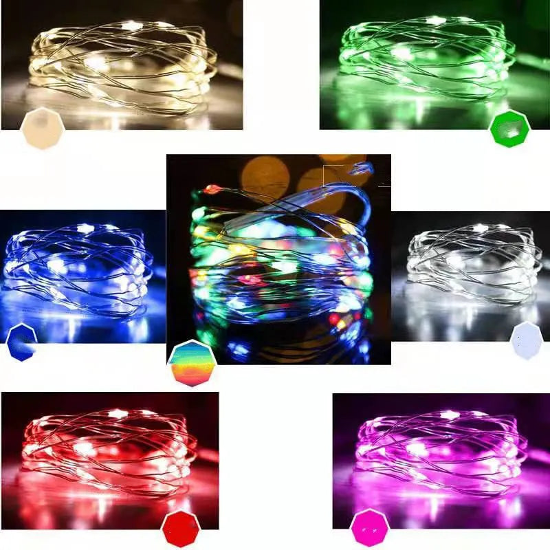 Flexible copper wire LED string light coiled on a table, showing small bulbs and a dual-power control box.