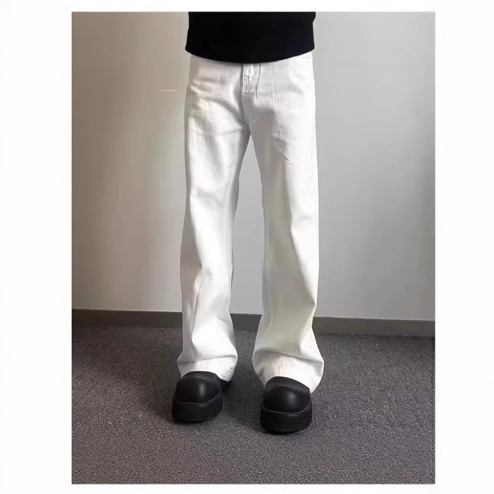 A pair of men's loose-fit white straight-leg cotton jeans on a plain background.