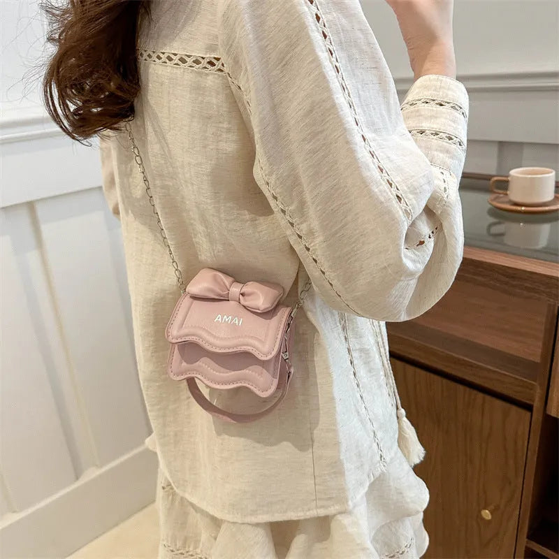 Mini crossbody bag in PU material with adjustable strap available in seven colours