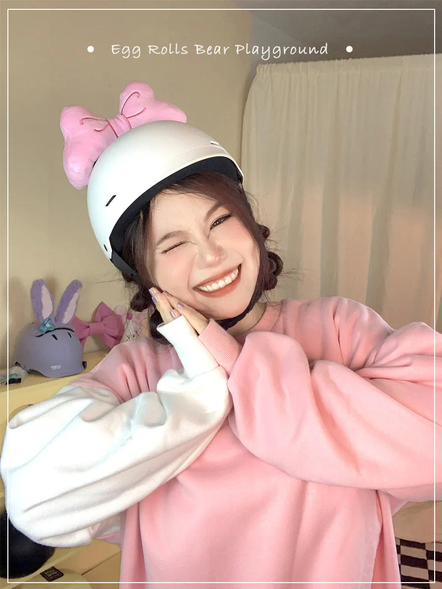 Soft plush bow decoration for helmets in red, peach pink, and rose pink colour options.