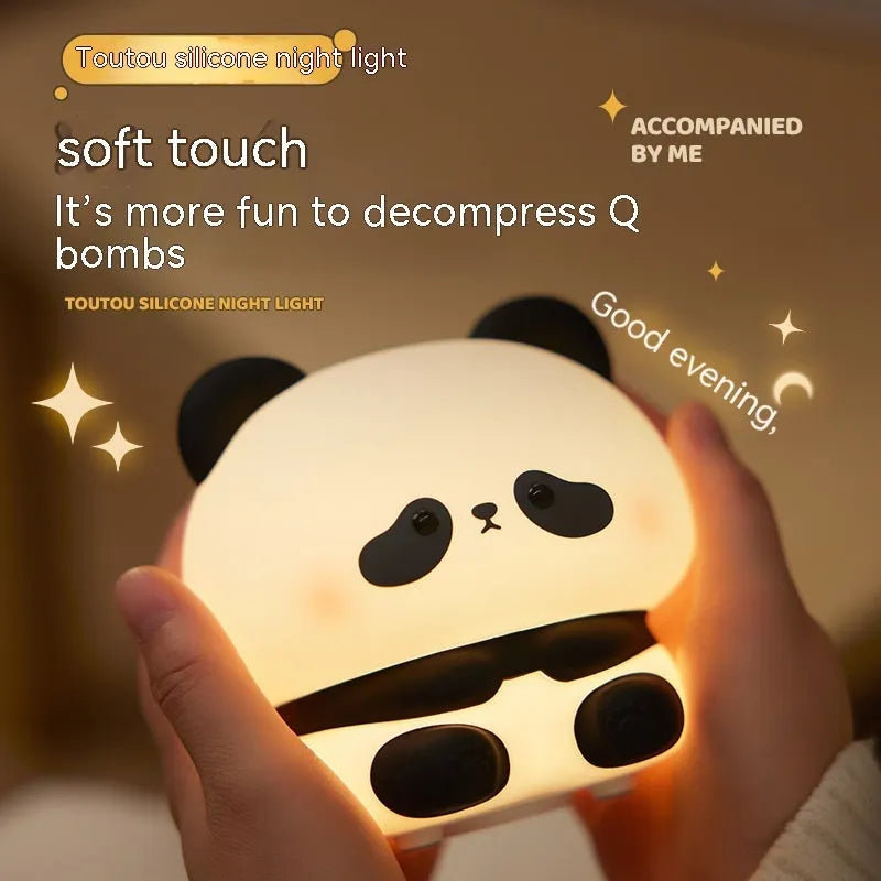 Cute panda LED night light with soft silicone cover, USB rechargeable, featuring colourful lighting modes on a bedside table.