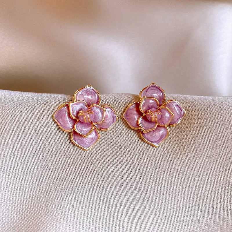 Golden-purple oil-spot glaze flower stud earrings on a copper base with surgical steel posts.