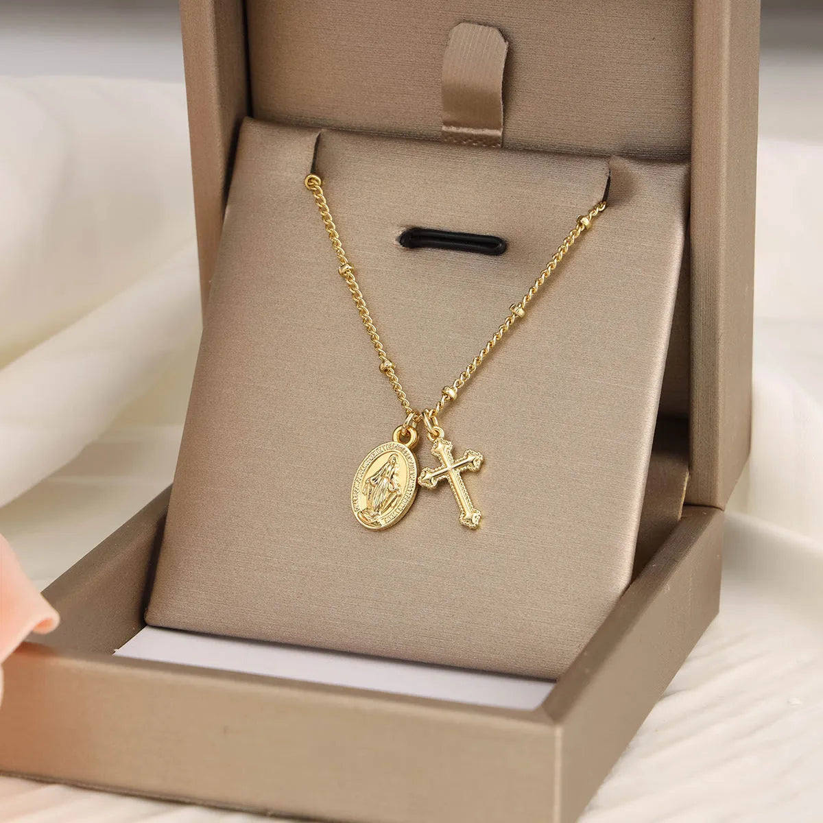 Geometric Virgin Mary cross pendant necklace in gold on a 45cm chain with lobster clasp.