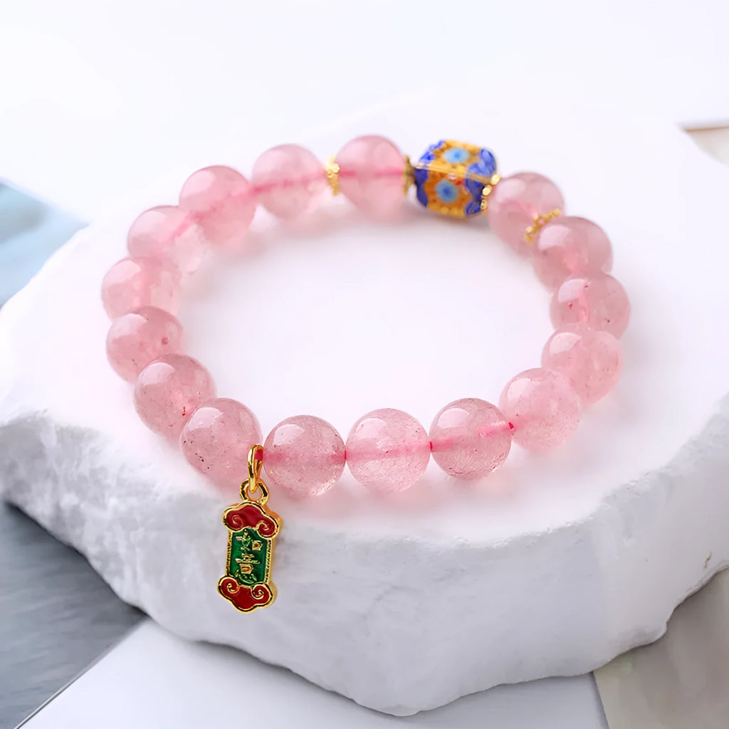Pink strawberry quartz crystal bracelet with hand-woven Ruyi symbols and text elements