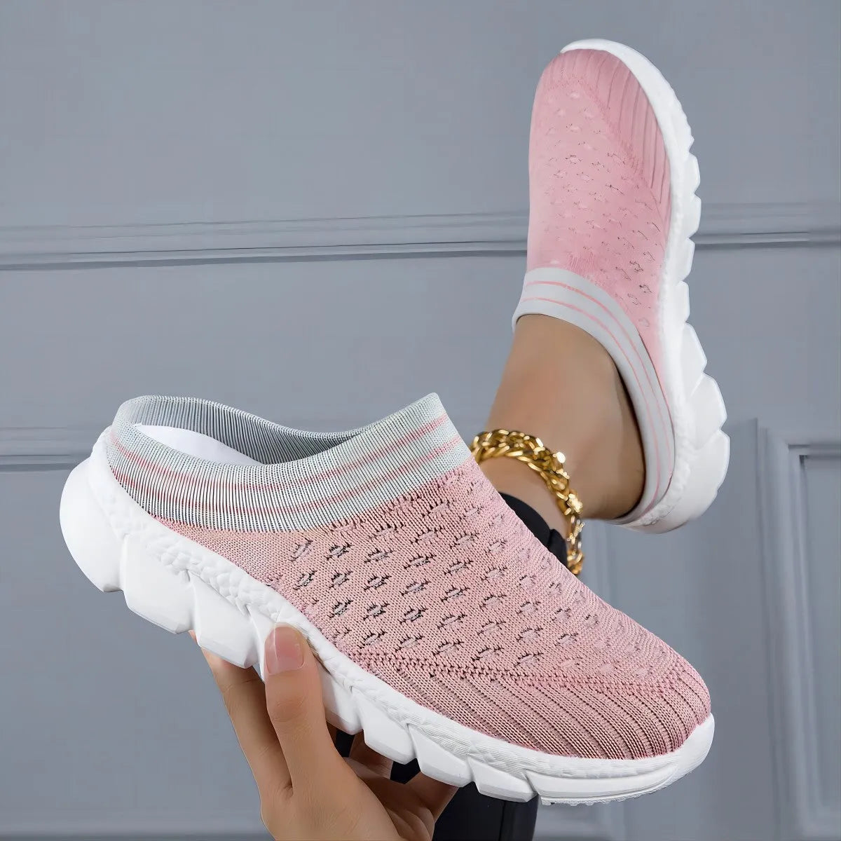 Women's Flyknit slipper shoes in a stripe pattern, showing hollowed-out design and sewing lines, on a viscose sole.