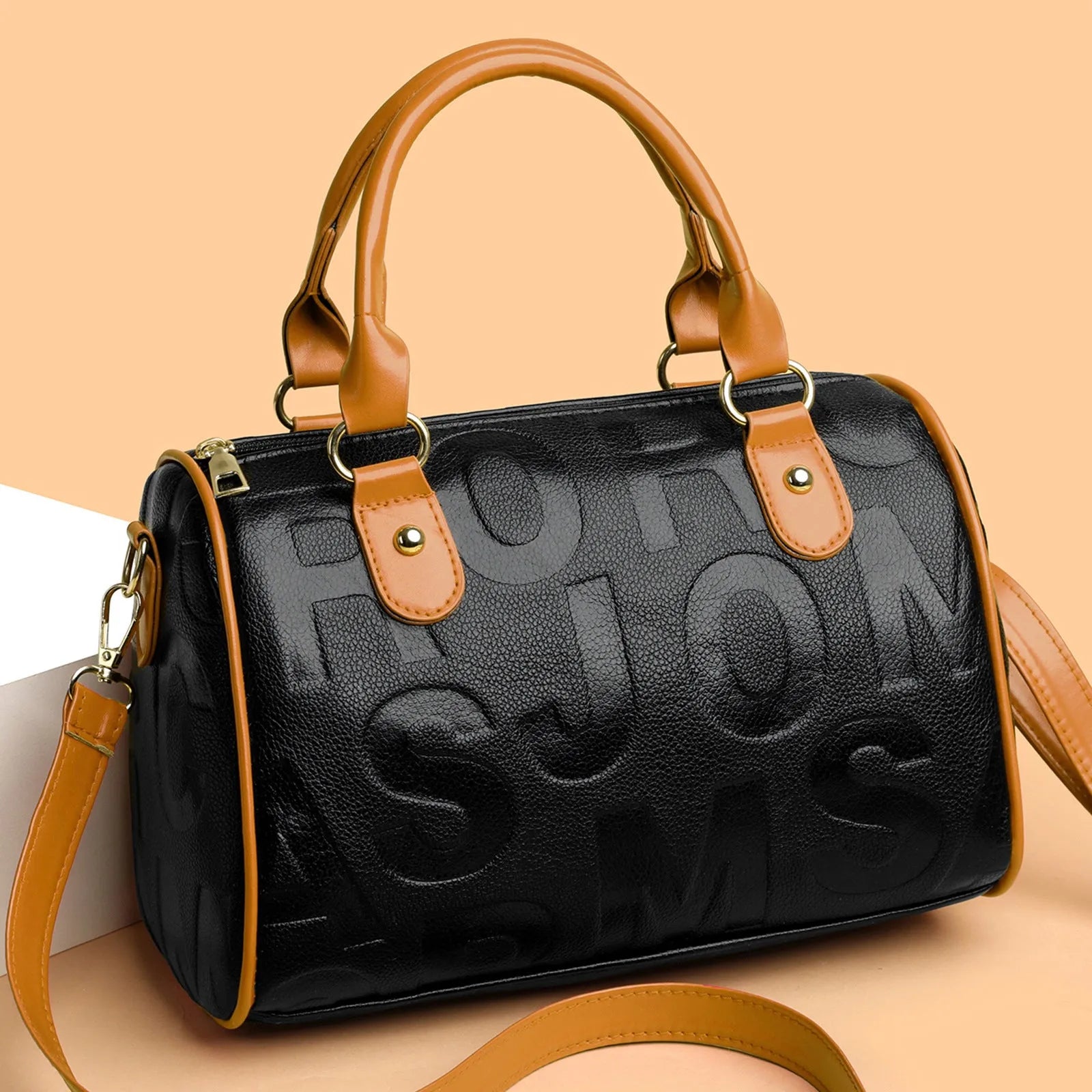 Brown cylindrical crossbody bag with three adjustable shoulder straps showing leather-like PU material texture