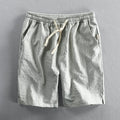 Men's striped casual loose shorts in light blue colour on a mid waist, showing the straight leg shorts cut.