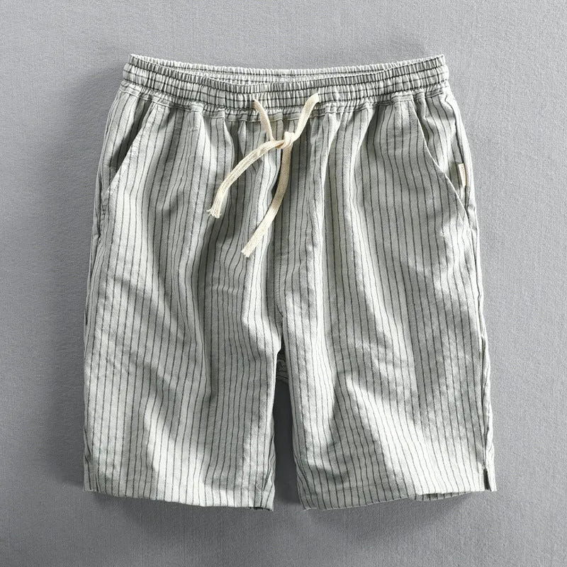 Men's striped casual loose shorts in light blue colour on a mid waist, showing the straight leg shorts cut.