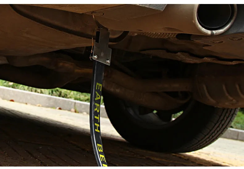 Black car electrostatic grounding belt, 37cm long with metal hook, shown against a vehicle tyre.