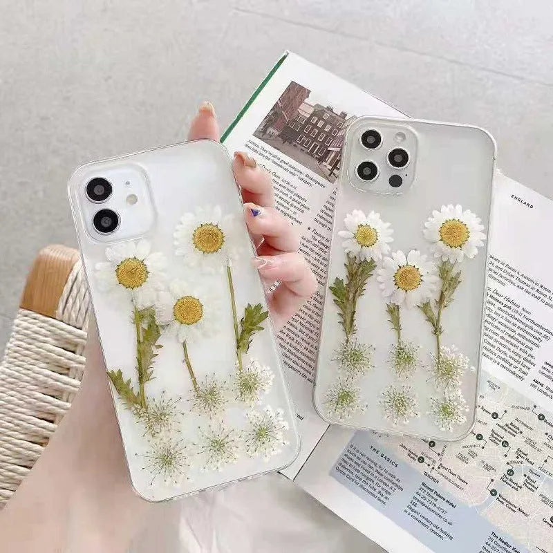 White TPU iPhone case with a raised epoxy daisy floral design on the back.