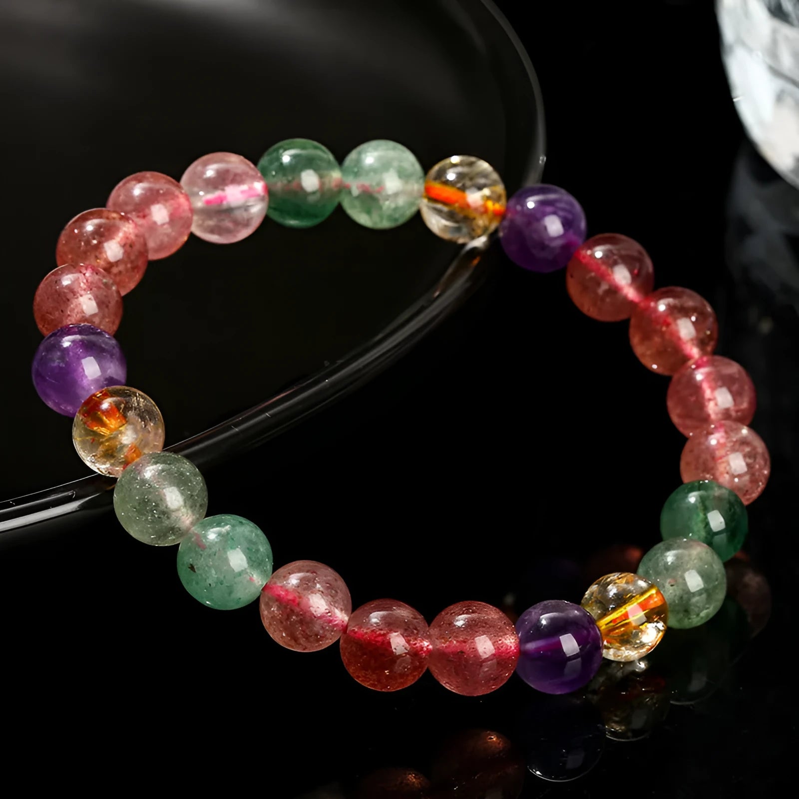 A women's bracelet with pink strawberry quartz and natural tourmaline beads in geometric shapes, showing 7mm, 8mm, and 9mm size options.