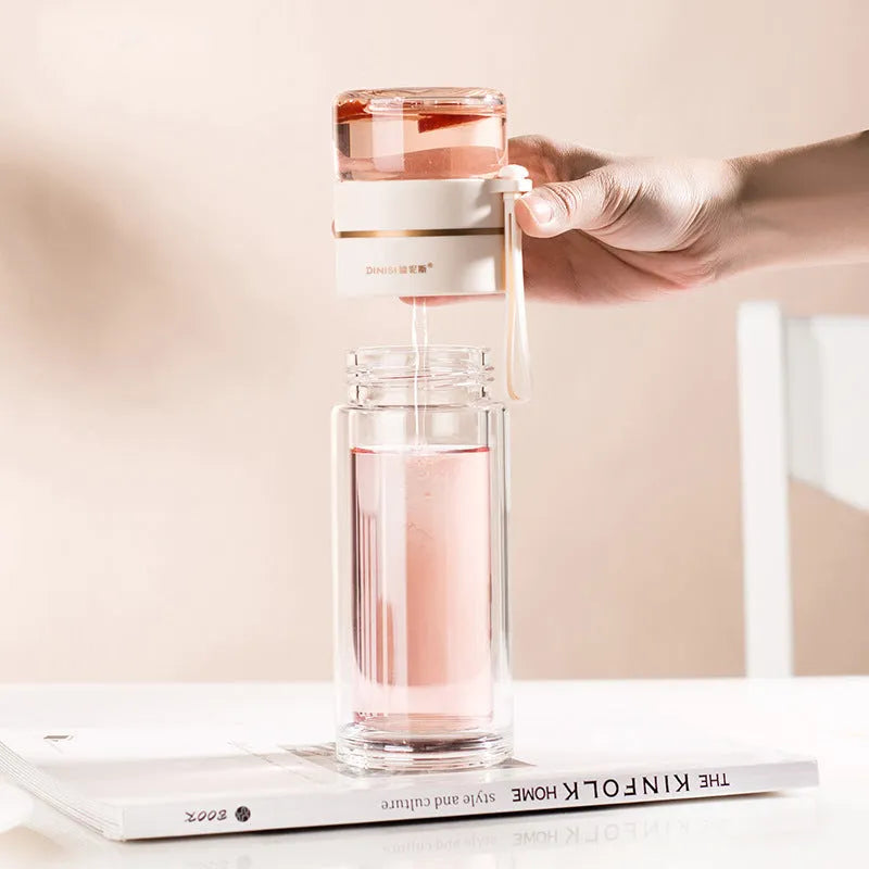 Double-wall glass water bottle with tea infuser insert and rope handle in assorted colours.