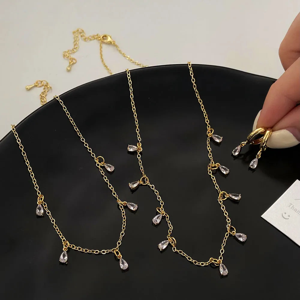 Zircon necklace, earrings, and anklet set for women with geometric meteor shower pendant.
