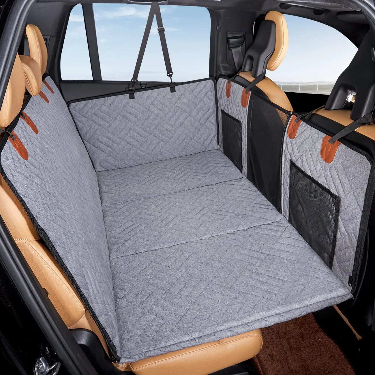 Black waterproof car dog bed cushion on rear seats protecting against pet mess
