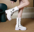 Black women's mid-calf knight boots with a metal buckle and side zip on a white background.