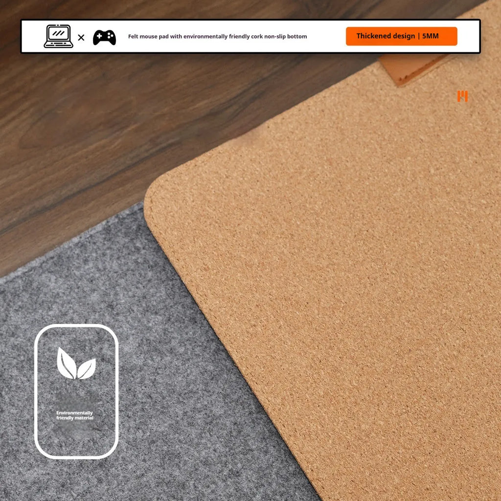 Oversized black and gray felt desk mat with cork base on a wooden desk