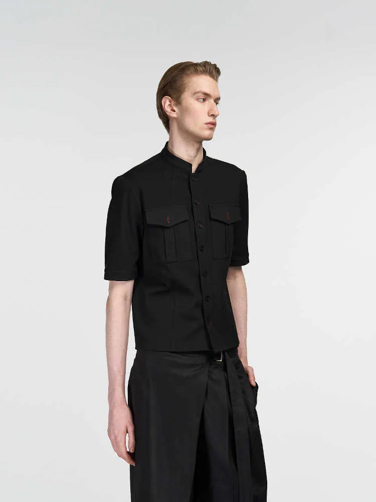 Handmade black loose fit half sleeve shirt with a shirt collar on a hanger.