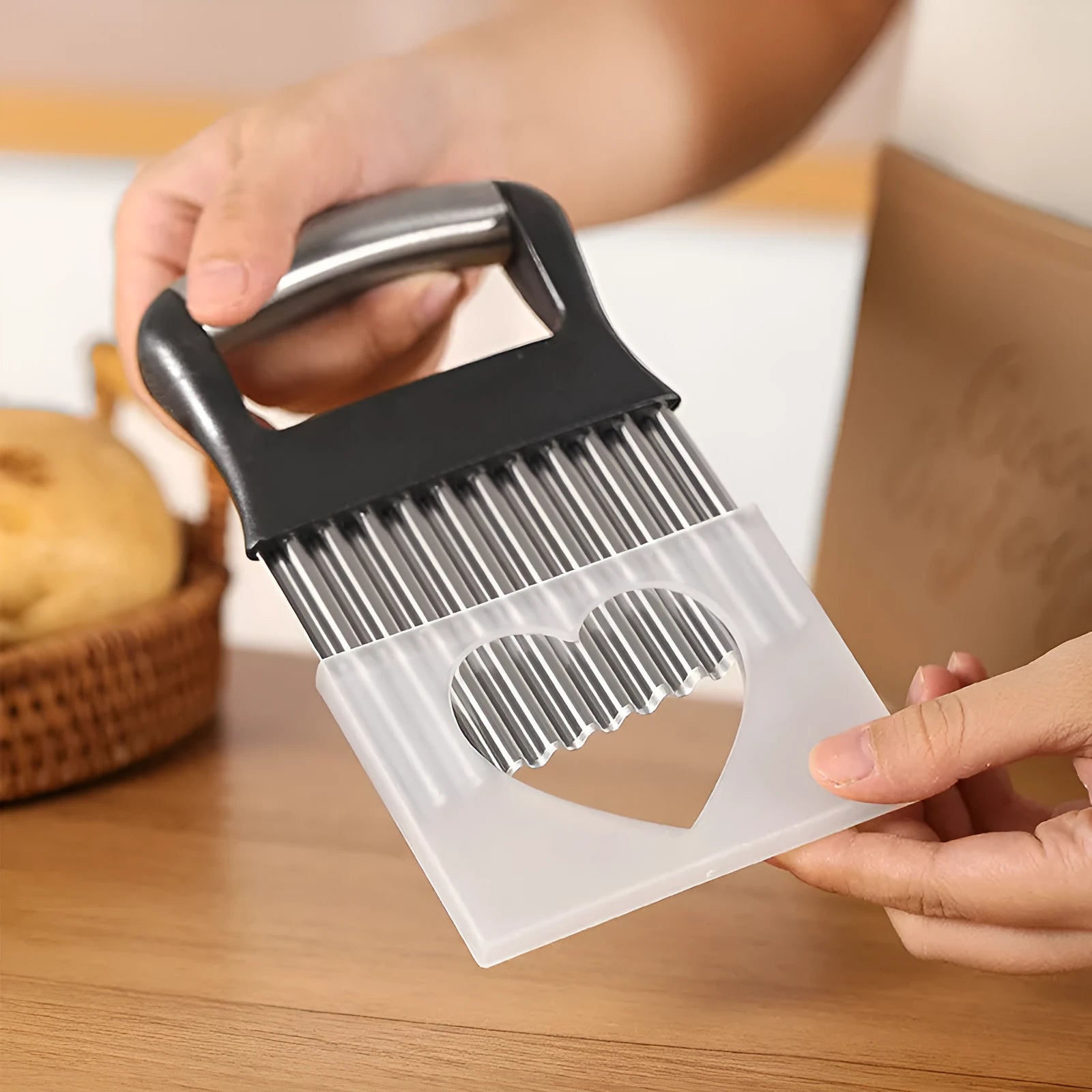 Stainless steel potato wave knife for making crinkle-cut chips on a wooden board