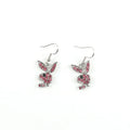 Close-up of a pair of cute rabbit-shaped stud earrings with sparkling cubic zirconia stones on a silver-coloured background.