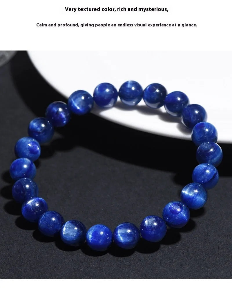 Polished blue geometric crystal bracelet with Ruyi design elements on a wrist.
