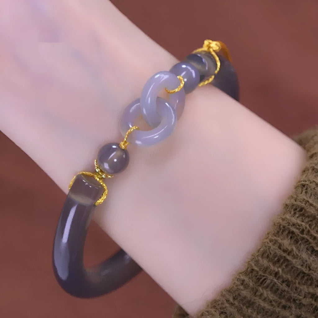 Grey retro-style half bracelet made from smoke purple agate with a visible metal ring buckle closure.