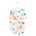 Colourful cartoon umbrella pattern dog raincoat on a pet, showing the polyester material and fit.