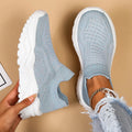 Light blue women's mesh slip-on sports shoes with woven design and round toe
