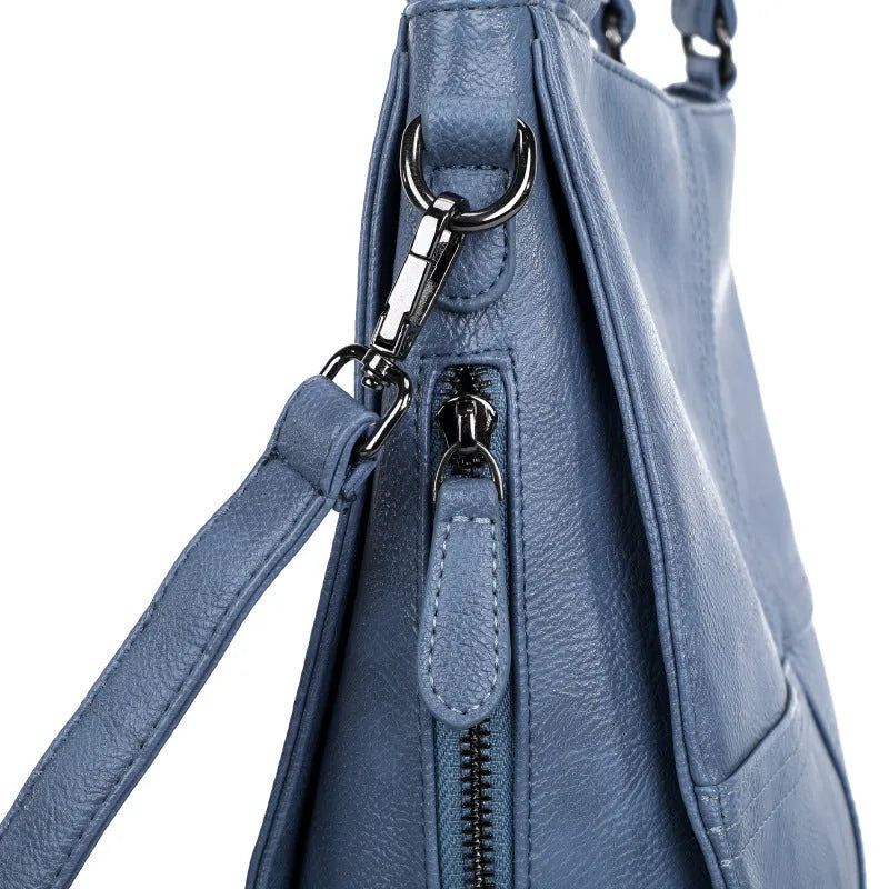 Soft PU leather crossbody handbag with barrel shape and vintage styling in light khaki colour