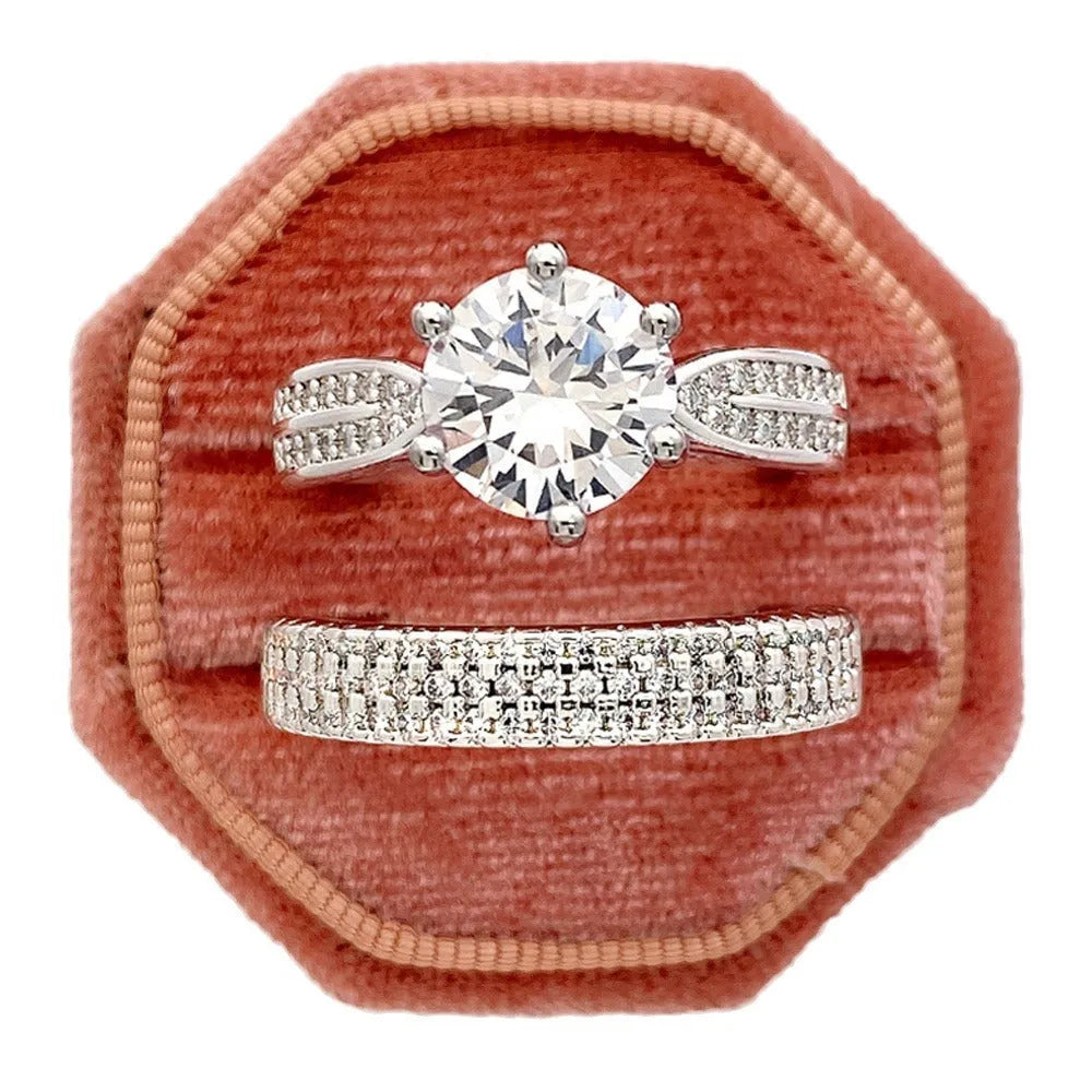 A geometric white gold-coloured alloy wedding ring bracelet on a finger, showing its continuous band design with a round detail.