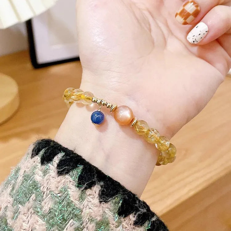 Gold rutilated quartz and sunstone crystal bracelet with diamond beads on adjustable band