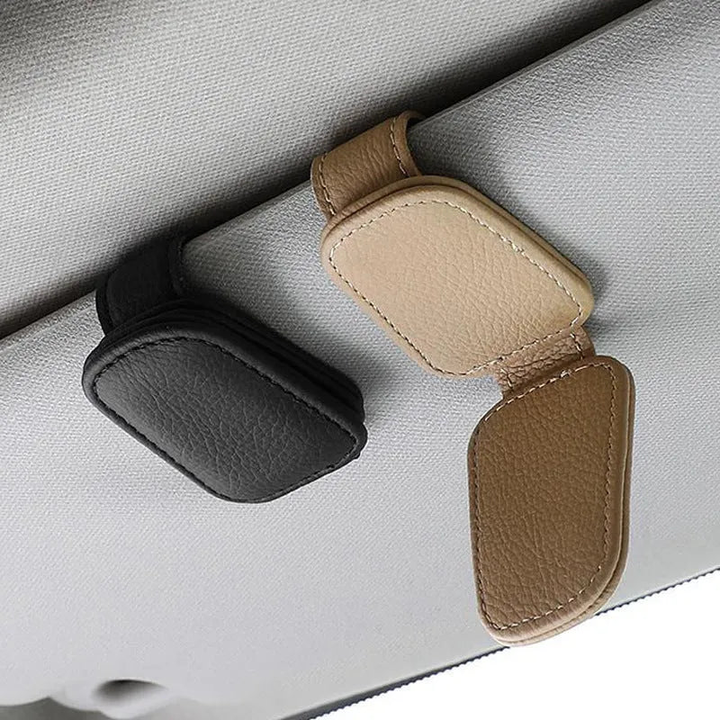 PU leather car sunglasses clip holder mounted on a grey sun visor.
