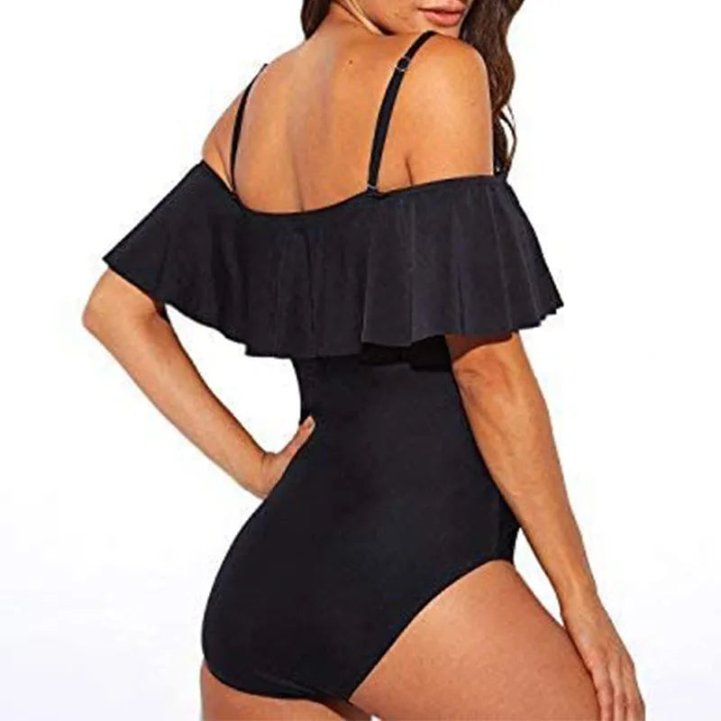 Black one-piece swimsuit with ruffled straps and cut-out details on a mannequin.